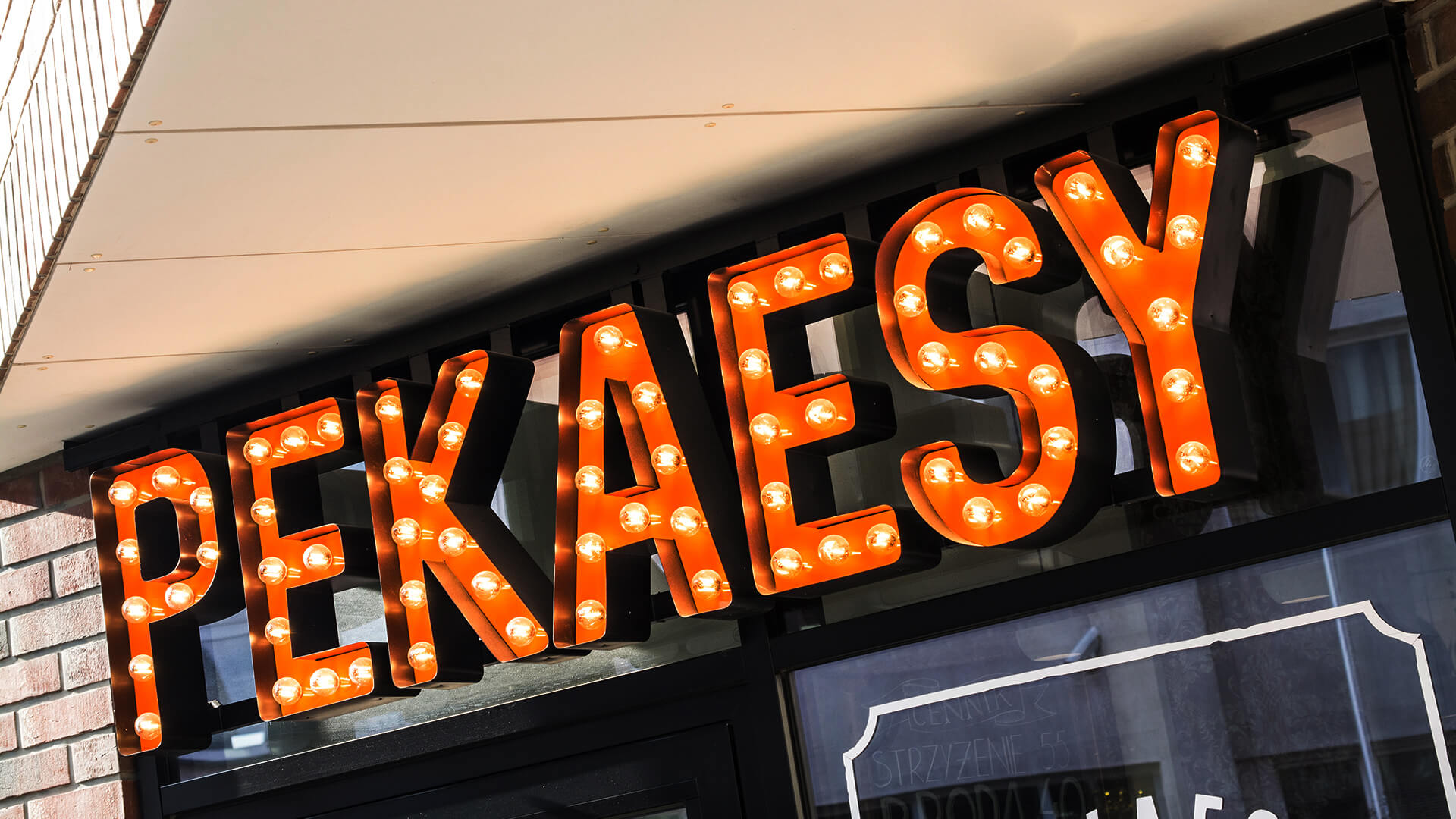 pekaesy hair salonbarber shop - pekaesy-letters-with-lights-over-the-entry-to-barbera-letters-with-coloured-on-heights-mounted-to-the-panel-on-the-window-with-company-logo-words-spatial-3d-poznan
